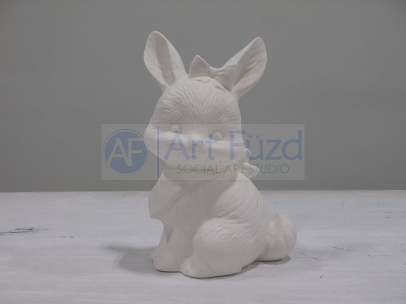 Small Sitting Bunny with Bow in Hair Looking Left