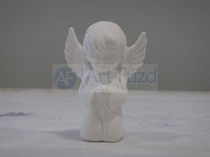 Small Boy Angel with Big Wings Kneeling and Praying